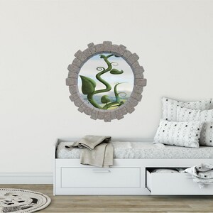 May include: A stone-framed window decal with a green vine growing up and out of it. The vine is against a background of a blue sky and green hills.