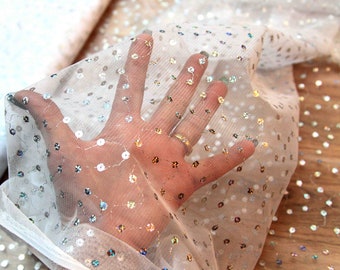 Fabric mesh  white with silver sequinsHologram  polyester mesh  56 inches wide sold by the 1/4 yard