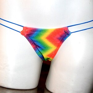 May include: Rainbow tie-dye thong underwear with blue elastic straps.