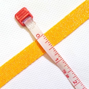 Trim 1/2 inch wide sparkle  light gold cheer leader athletic uniform  school pom pom  team price per yard