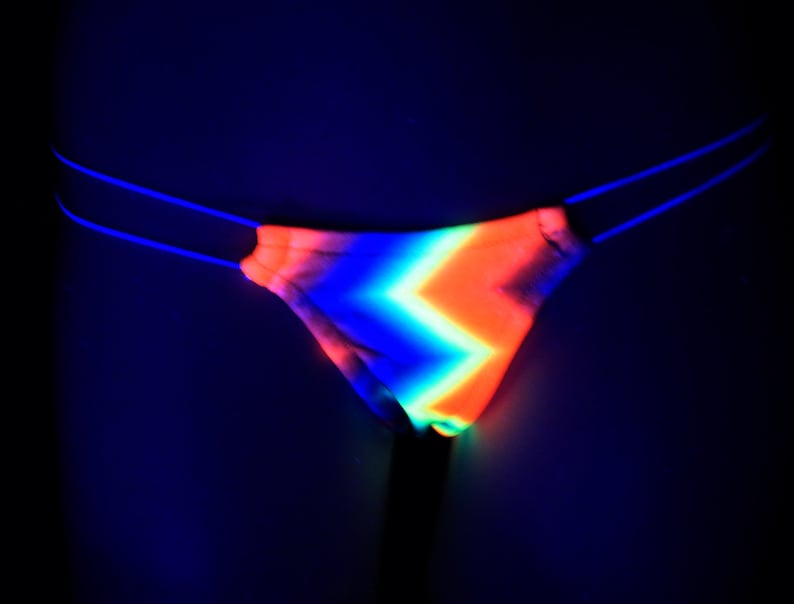 May include: A neon pink, orange, blue, and green striped thong with a black elastic waistband.