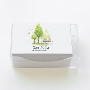 May include: A stack of white business cards with a watercolor illustration of trees and a bench. The text "Grace For Five Design Studio" is printed on the cards.