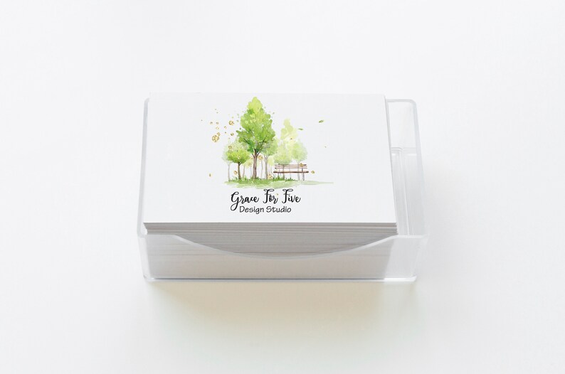 May include: A stack of white business cards with a watercolor illustration of trees and a bench. The text "Grace For Five Design Studio" is printed on the cards.