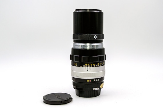 Nikon Nikkor-Q Auto 200mm f/4  Telephoto Zoom Lens with a built-in hood for Nikon F 35 mm SLR cameras.