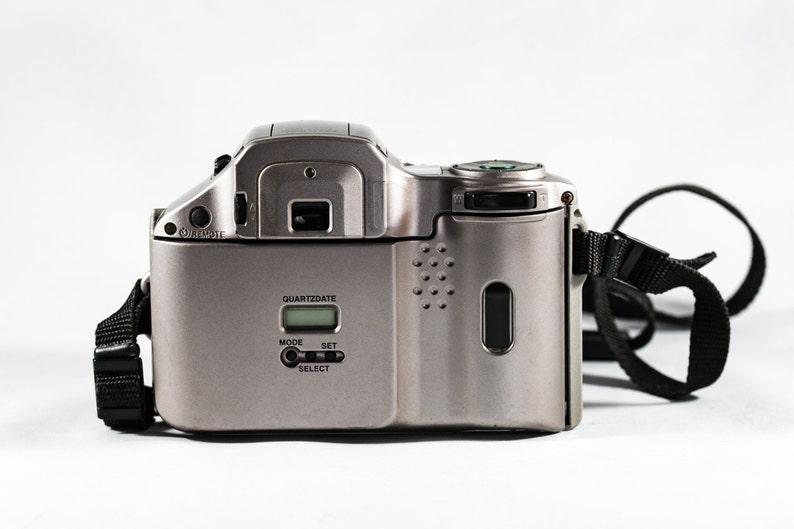 OLYMPUS IS-20200 QuartzDate All-in-One Camera with 28mm 110mm Aspherical Lens.