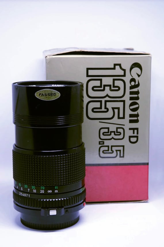 Canon FD 135MM F3.5 Telephoto Lens with genuine leather carrying case, all manuals and documentation, in original box.