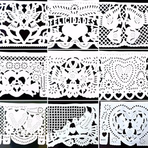 May include: Nine white paper banners with intricate cut-out designs, including hearts, flowers, birds, and the word "FELICIDADES". The banners are arranged in a grid pattern against a black background.