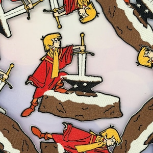 May include: Embroidered patches featuring a cartoon illustration of a young person in a red robe pulling a sword from a stone. The patches have a white background and include other swords and figures.