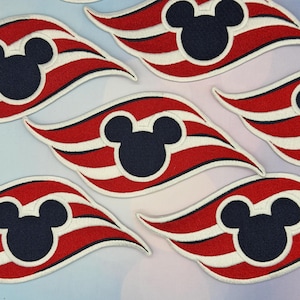 May include: A collection of embroidered patches. Each patch features a navy blue Mickey Mouse silhouette, red and white stripes, and a white border. These patches are suitable for customising clothing or accessories.
