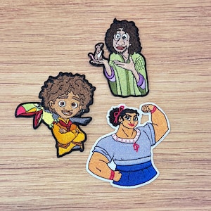 May include: Three embroidered patches featuring characters from an animated movie. One patch depicts a man with curly brown hair holding a rat. Another shows a young man with a toucan. The third patch shows a woman flexing her arm.