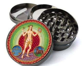 May include: A metal grinder with a colorful image of a woman holding a mirror and a scale. The image is surrounded by a green, red, and orange circular border. The grinder has a metal lid and a metal bottom.