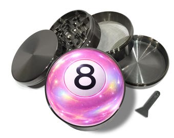 May include: A disassembled, metallic gray herb grinder with a pink and purple 8-ball design. The grinder is made of multiple parts, including a lid, a grinding chamber, a mesh screen, and a bottom chamber. A small, gray scraper is also included.