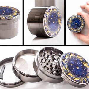 May include: A silver metal grinder with a blue and gold zodiac design. The grinder has four parts, including a top lid, a grinding chamber, a screen, and a bottom collection chamber.