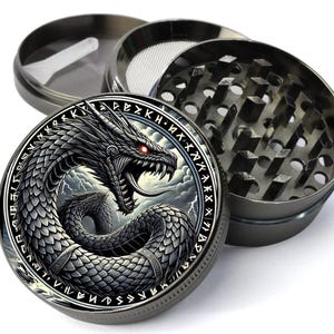 May include: A black metal grinder with a dragon and runes design. The grinder has a three-piece design with a screen and a herb chamber.
