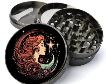 May include: A metal grinder with a black and red design featuring a woman's face with flowing red hair, a crescent moon, and stars. The grinder has a three-piece design with a screen and a grinder.