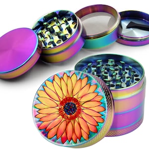 May include: A four-piece metal grinder with a sunflower design on the top. The grinder has a rainbow iridescent finish.