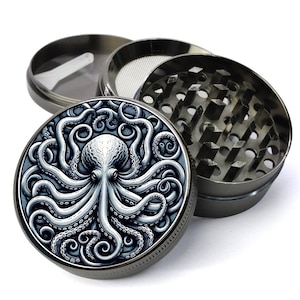 May include: A black metal grinder with a silver octopus design on the lid. The grinder has three parts: a top lid, a middle section with a screen, and a bottom section with teeth.