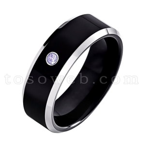 May include: A black tungsten carbide ring with a silver band and a small purple gemstone set in the center.