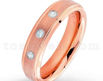 May include: A rose gold wedding band with a brushed finish and three small diamonds set into the band.
