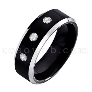 May include: A black tungsten carbide ring with a silver band and three small diamonds set into the black surface.