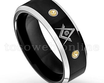 May include: Black tungsten carbide ring with a silver band and a silver Masonic symbol. The ring has three small yellow gemstones.