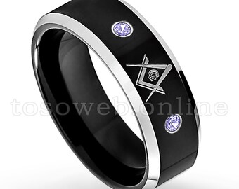 May include: A black and silver tungsten carbide ring with a silver Masonic symbol and two purple gemstones.