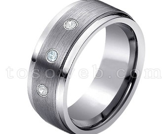 May include: A brushed silver tungsten carbide ring with three small diamonds set into the band.