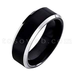 May include: A black tungsten carbide ring with a silver band around the edge.