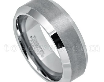 May include: A silver tungsten carbide ring with a beveled edge and a brushed finish. The ring has a polished center band and the words "Tungsten Carbide" engraved on the inside.