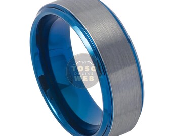 May include: A blue and silver tungsten carbide ring with a brushed finish. The ring has a blue inner band and a silver outer band.
