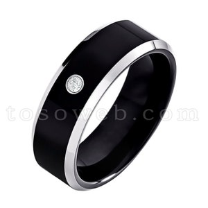 May include: A black tungsten carbide ring with a silver band and a single diamond set in the center.