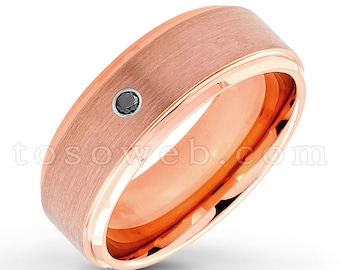 May include: A rose gold wedding band with a brushed finish and a single black diamond set in the center.