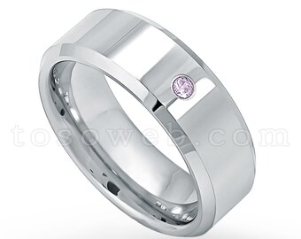 May include: A silver wedding band with a single, small, pink gemstone set into the top of the band.