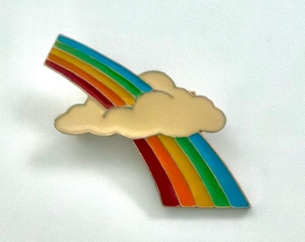 Vintage 1970’s diagonal enamel multi-colored rainbow passing behind a stylized cloud pin