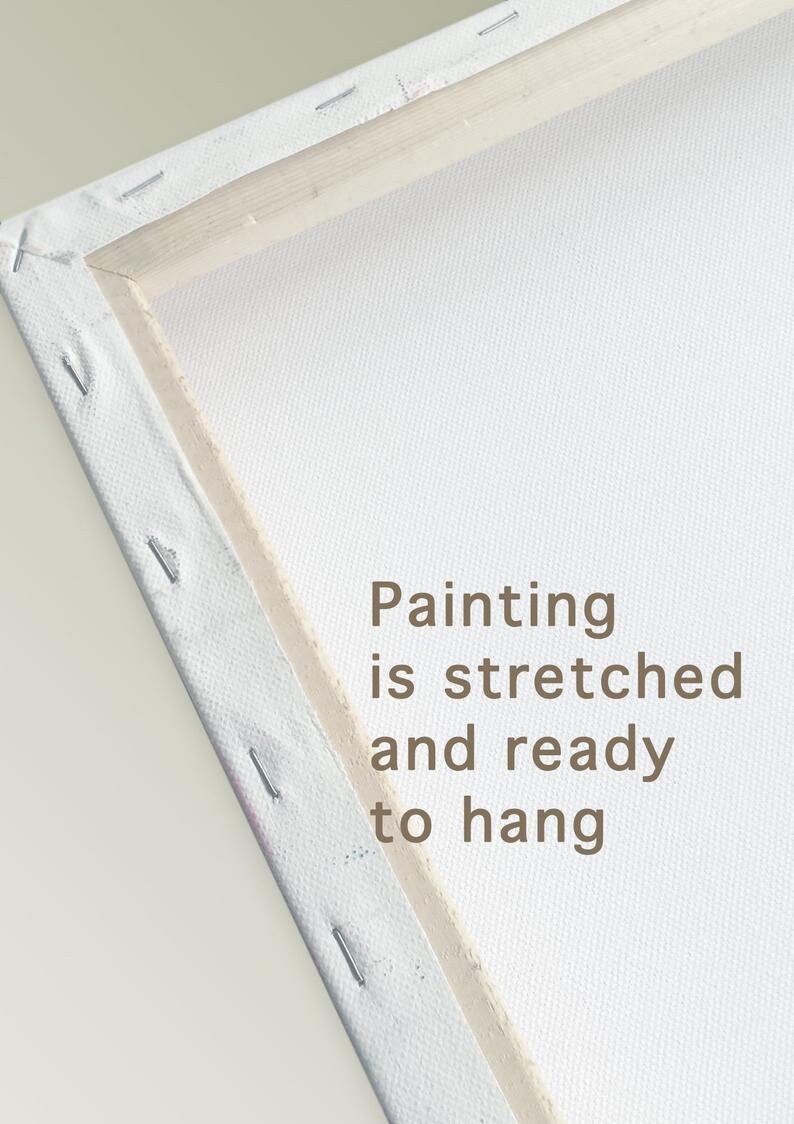May include: Close-up of the edge of a stretched canvas painting. The canvas is white and the wooden frame is natural wood. The text "Painting is stretched and ready to hang" is printed on the canvas.