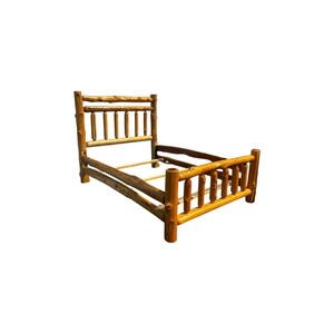 May include: A bed frame constructed from natural, light brown cedar logs. The headboard and footboard feature a series of vertical log spindles connected by horizontal log rails. The frame includes side rails and support slats for a mattress.