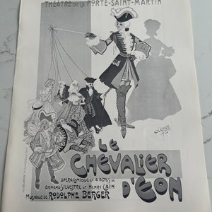 May include: Black and white poster advertising the operetta "Le Chevalier d'Eon" at the Theatre de la Porte Saint-Martin. The poster features a drawing of a man in a military uniform holding a sword, with a group of people in the background.