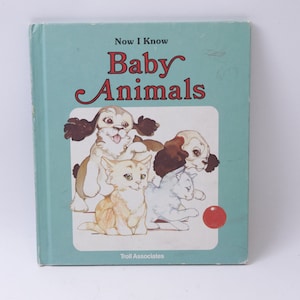 May include: A blue book with the title "Now I Know Baby Animals" and a picture of three baby animals playing with a red ball. The book is published by Troll Associates.