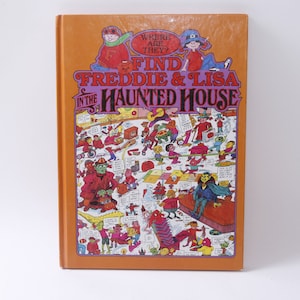 May include: An orange book cover with the title "Find Freddie & Lisa in the Haunted House" and an illustration of a haunted house with many characters.