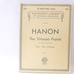 Puede incluir: Una portada de libro vintage para "El Pianista Virtuoso" de Hanon, parte de la Biblioteca Schirmer de Clásicos Musicales. La portada es de color crema con un borde verde y presenta el título en letras verdes grandes.
