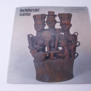 May include: A book cover featuring a brown wooden sculpture of four figures. The book title is "The Potter's Art in Africa" and the authors are William Fagg and John Picton. The book is published by The British Museum.