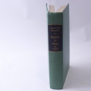 May include: A green hardcover book with the title "Rabble in Arms" by Kenneth Roberts. The book is part of the Literary Guild.