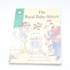 May include: A children's book cover with a yellow background and the title "The Royal Baby-Sitters". The cover features illustrations of a queen, a king, a baby in a stroller, and a giraffe.