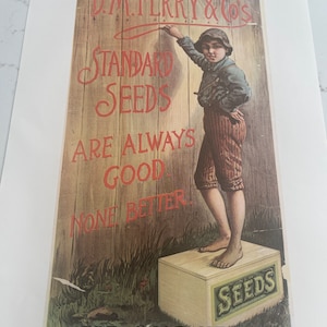 May include: A vintage advertisement for D.M. Ferry & Co's Standard Seeds. A young boy in overalls is writing on a wooden fence with the text 'Standard Seeds Are Always Good None Better'. A box of seeds is on the ground with the text 'New Seeds'. The text 'For Sale Here' is at the bottom of the advertisement.