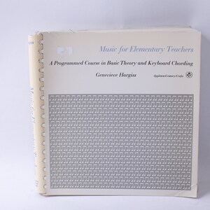 May include: A white book with a grey cover featuring a pattern of musical notes. The title is "Music for Elementary Teachers" and the subtitle is "A Programmed Course in Basic Theory and Keyboard Chording". The author is Genevieve Hargiss.