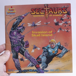 May include: A vintage "Sectaurs: Warriors of Symbion" book cover. The cover features illustrations of insect-like warriors in purple and blue, with the title "Invasion of Skall Island". The Kid Stuff Records & Tapes logo is visible.