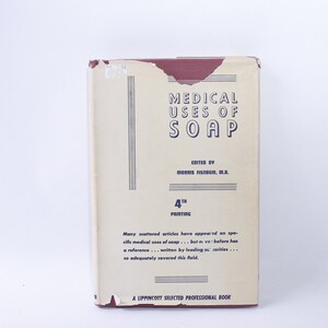 May include: The spine of a book titled "Medical Uses of Soap" with the author listed as Morris Fishbein, M.D. The book is a 4th printing and is a Lippincott Selected Professional Book.