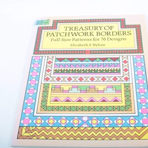 May include: A book titled "Treasury of Patchwork Borders" with full-size patterns for 76 designs by Elizabeth E. Nyhan. The cover features a colorful patchwork design with geometric shapes in red, pink, yellow, blue, and green.