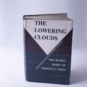 May include: A hardcover book titled "The Lowering Clouds" with a white and black cover design. The book's spine is dark blue with red and black stripes. The text "The Secret Diary of Harold L. Ickes" is also visible.