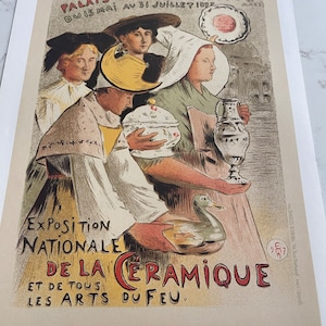 May include: A vintage poster advertising the National Exhibition of Ceramics and Fire Arts. The poster features a group of people holding ceramic objects, including a duck, a pitcher, and a bowl. The text on the poster reads "Exposition Nationale de la Céramique et de tous les Arts du Feu."